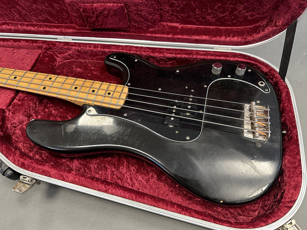 Vintage black electric bass guitar with maple fretboard in red velvet lined hard case