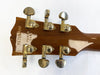 Back of guitar headstock showing serial number 91318500, Made in USA stamp, and six gold Grover tuning pegs on a polished wooden neck