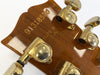 Back of guitar headstock showing serial number 91316500 and "Made in USA" stamp with gold Grover tuning pegs