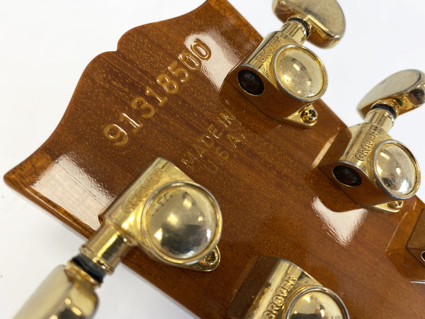 Back of guitar headstock showing serial number 91316500 and "Made in USA" stamp with gold Grover tuning pegs