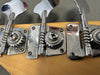 Close-up of vintage Fender bass guitar tuning pegs with chrome finish on a natural wood headstock