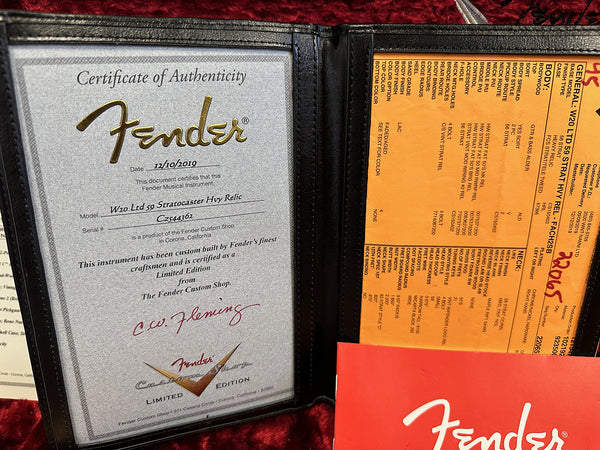 Fender Certificate of Authenticity for W20 Ltd 59 Stratocaster Hvy Relic signed by C.W. Fleming with detailed Fender Custom Shop limited edition specifications sheet and red Fender booklet on red plush background