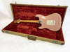 Pink electric guitar with maple neck inside open vintage tweed guitar case with red plush lining from Coffee House Guitars