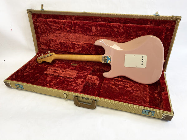 Pink electric guitar with maple neck inside open vintage tweed guitar case with red plush lining from Coffee House Guitars