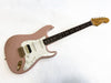 Fender Stratocaster electric guitar in pink with white pickguard and rosewood fingerboard, gold hardware, and humbucker-single-single pickup configuration.