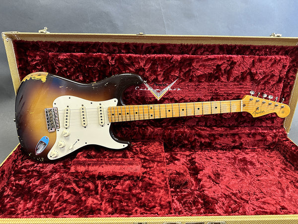 Vintage Fender Stratocaster electric guitar with sunburst finish and maple neck in open tweed hard case with red plush interior