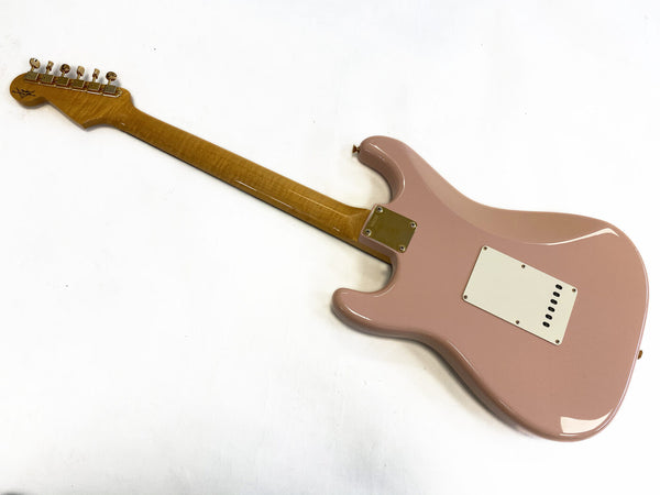 Back view of pink electric guitar with maple neck and six tuning pegs against white background