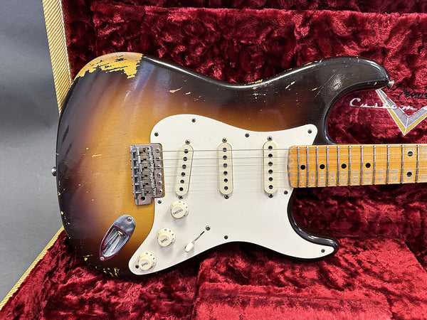 Vintage sunburst electric guitar with three single-coil pickups and maple neck in red plush guitar case