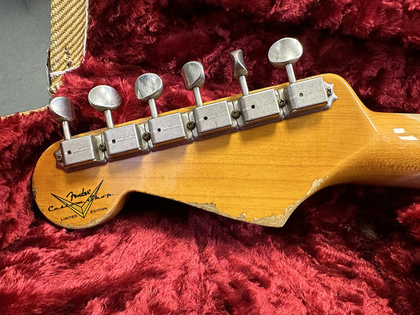 Close-up of Fender Custom Shop Limited Edition guitar headstock with vintage Kluson tuning pegs and natural wood finish on red plush guitar case lining