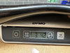 Close-up of DYMO digital scale display showing weight 3.42 kg used for weighing guitars at Coffee House Guitars