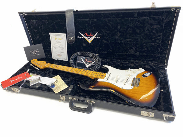 Fender Custom Shop vintage sunburst Stratocaster electric guitar in black velvet lined hard case with certificate of authenticity, guitar strap, tremolo arm, and Fender tags and paperwork.