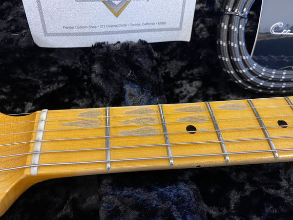 Close-up of maple guitar neck and frets with aged patina and vintage-style inlays on a Fender Custom Shop electric guitar