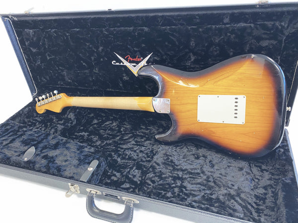 Vintage Fender Custom Shop Stratocaster guitar in sunburst finish shown from back inside black plush-lined Fender hard case