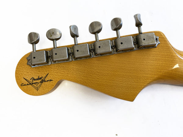Vintage Fender Custom Shop guitar headstock with six vintage-style tuning machines on glossy natural wood finish against a white background