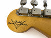 Close-up of Fender Custom Shop guitar headstock with vintage tuning pegs and logo on natural wood finish