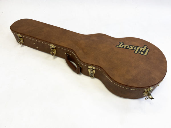 Brown Gibson guitar hard case with brass clasps and handle on white background