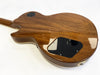Back view of Coffee House Guitars electric guitar with polished natural wood finish and black plastic control cavity covers on white background