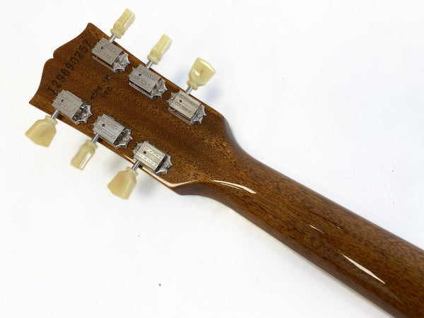 Back of mahogany guitar neck with vintage tuners and cream tuning pegs on white background for Coffee House Guitars product listing.