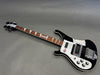 Black Rickenbacker electric bass guitar with white pickguard and triangular fret inlays on wooden neck