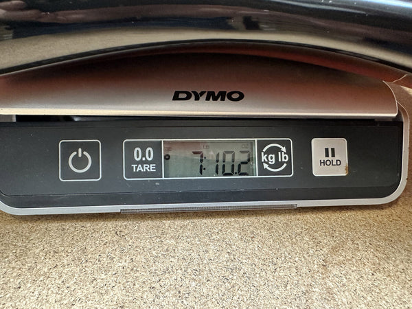 Digital scale displaying 7 pounds 10.2 ounces weight for Coffee House Guitars product measurement