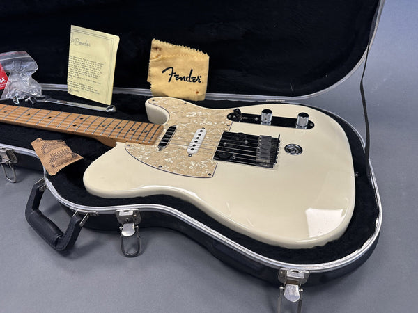 Vintage white Fender Telecaster electric guitar with maple neck and pearl pickguard in black hardshell case, includes Fender polishing cloth and original paperwork