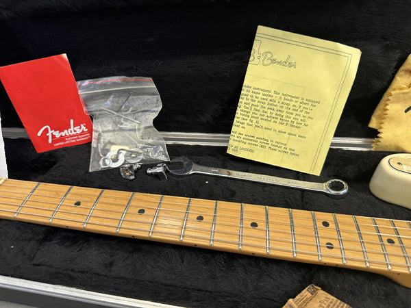 Fender guitar neck with maple fretboard inside guitar case, includes Fender warranty booklet, B-Bender instruction manual, guitar setup wrench, and small hardware parts in plastic bag.
