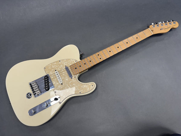 Fender Telecaster electric guitar with cream body, maple neck, and pearloid pickguard on gray background