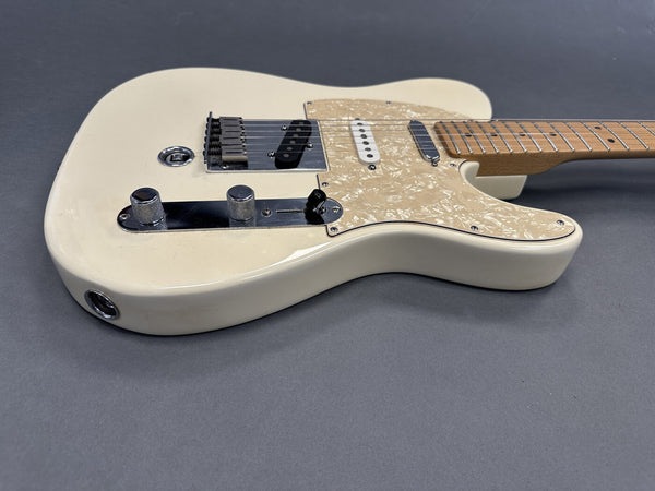 Cream electric guitar with pearloid pickguard and maple neck, two pickups and chrome control knobs on gray background