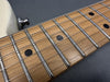 Close-up of guitar neck and fretboard with metal frets, black dot inlays, and steel strings on light wood finish electric guitar by Coffee House Guitars