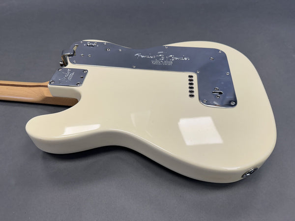 Fender electric guitar back body with vintage white finish and chrome control plate on gray background