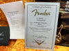 Certificate of Authenticity for Fender '60 Telecaster Journeyman guitar with serial number R102300 from Fender Custom Shop, dated 10/11/2019, placed on a yellow plush surface alongside a Coffee House Guitars Pre Sales Check List and Fender Custom Shop brochure.