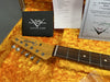 Close-up of Fender Telecaster guitar headstock and fretboard in orange plush-lined guitar case with Fender Custom Shop Care booklet and certificate of authenticity