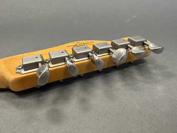 Close-up of vintage metal tuning pegs on maple guitar headstock with gray background, Coffee House Guitars product listing image