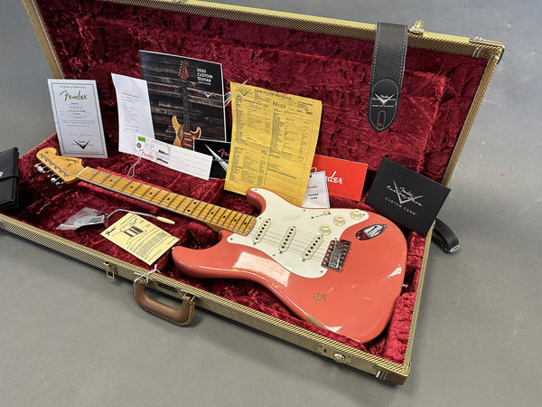 Fender Custom Shop 2020 Relic Stratocaster guitar in surf green with maple neck and case, including Fender Certificate of Authenticity, custom care booklet, owner's manual, and shop floor traveler displayed on red velvet guitar case lining.