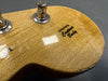 Close-up of guitar headstock with "Original Contour Body" decal, natural wood finish, and metal tuning pegs.