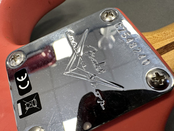 Close-up of Fender Custom Shop guitar neck plate with serial number CZ548240 on red guitar body