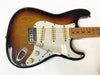 Sunburst electric guitar with maple neck and three single-coil pickups on white pickguard with volume and tone knobs