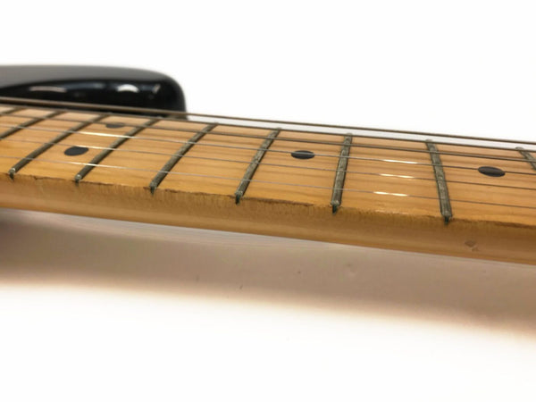 Close-up view of maple guitar neck and fretboard with dot inlays and worn wood finish on Coffee House Guitars electric guitar