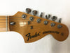 Fender Stratocaster guitar headstock with six chrome tuning pegs and strings attached, natural wood finish, original contour body text on headstock