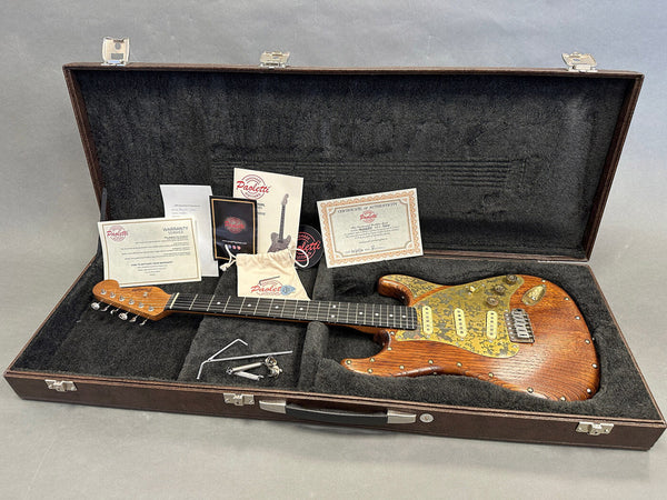 Paoletti handcrafted electric guitar with wood finish and gold pickguard in open black plush-lined guitar case with warranty, certificate of authenticity, manuals, and accessories