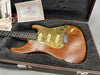 Paoletti handmade electric guitar with wooden body, rustic brass pickguard, and vintage-style pickups in a plush-lined guitar case with certificate of authenticity from Coffee House Guitars.