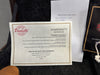 Paoletti Guitars warranty service registration card and Coffee House Guitars pre sales checklist with the make and model "Paoletti Sina" and serial number 93520 on black guitar case lining.