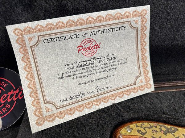 Certificate of authenticity for Paoletti handmade guitars with model and serial number information placed inside a guitar case.