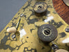 Close-up of vintage guitar control plate with tarnished metal finish, aged volume and tone knobs marked "Fiocchi Italy 12", and cream-colored toggle switch tip.