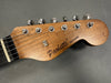 Close-up of Paoletti Guitars wooden electric guitar headstock with six tuning pegs and strings on gray background