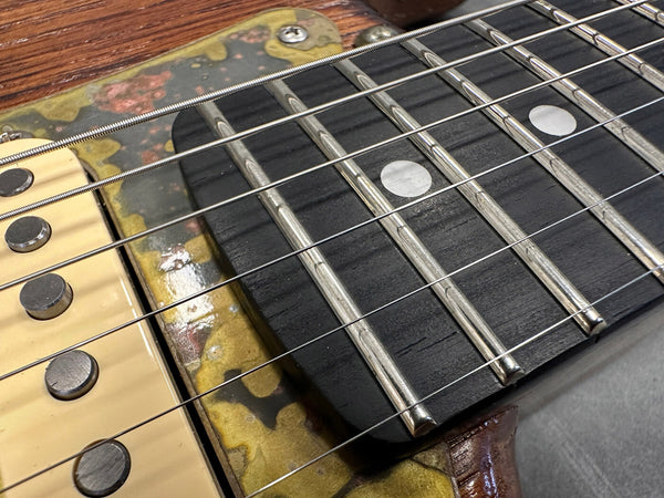 Close-up detail of electric guitar fretboard with metal frets, dot inlays, and aged pickup cover on Coffee House Guitars product listing