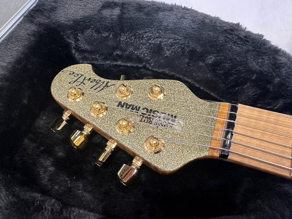Sterling by Music Man Albert Lee guitar headstock with gold sparkle finish and gold tuning pegs in black plush guitar case
