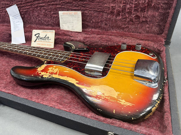 Vintage Fender Precision Bass guitar with sunburst finish and worn body in plush red guitar case with Fender owner's manual and paperwork