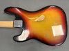 Vintage sunburst electric guitar body with visible wear and paint chipping, maple neck, and metal neck plate on gray background