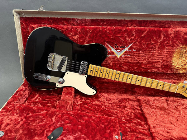 Black Fender Telecaster electric guitar with maple neck and vintage-style bridge pickup in red plush-lined Fender Custom Shop limited edition guitar case